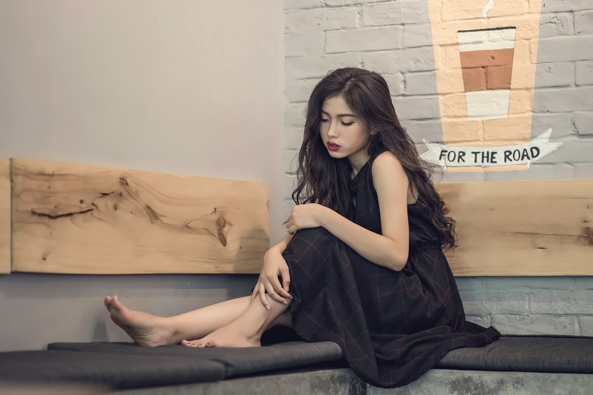 A sitting sad girl in black