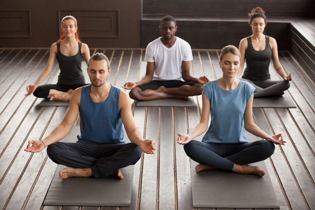 best meditation online course is being practiced by a group of young yogis